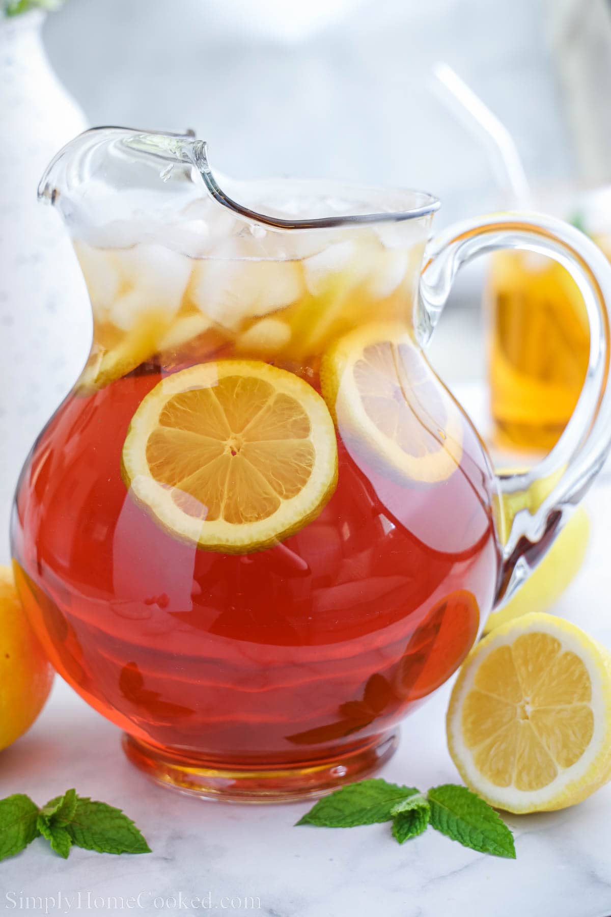 A pitcher of Sweet Tea with lemon slices and ice. 