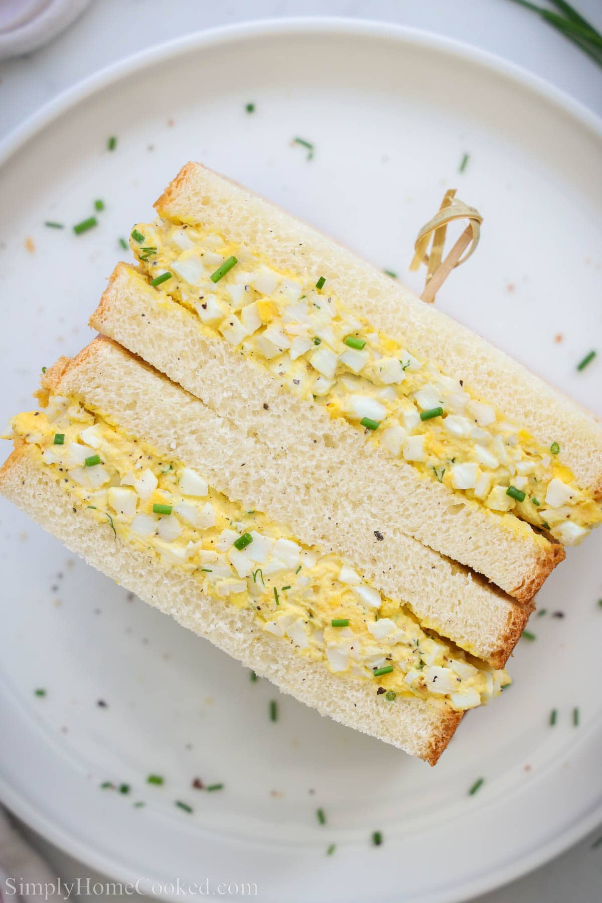 Egg Sandwich cut in half and stacked, held together with a toothpick.