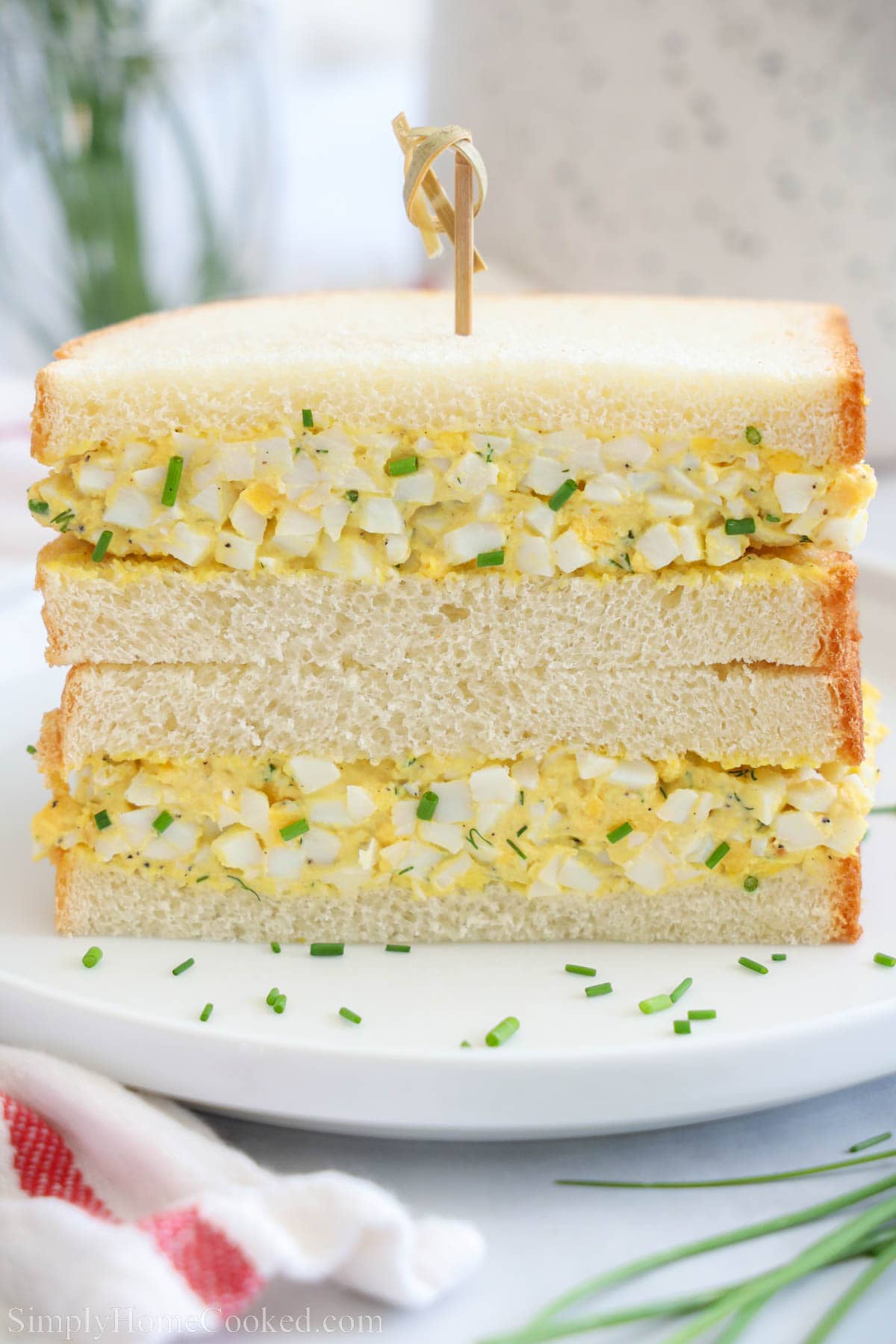Egg Sandwich cut in half and stacked with a toothpick through the center.