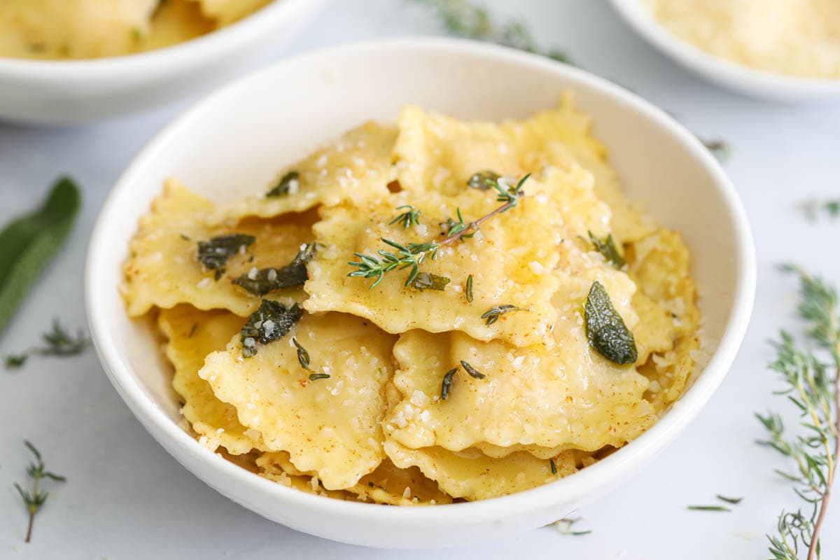 Butternut Squash Ravioli topped with fresh thyme, sage, and Parmesan cheese.