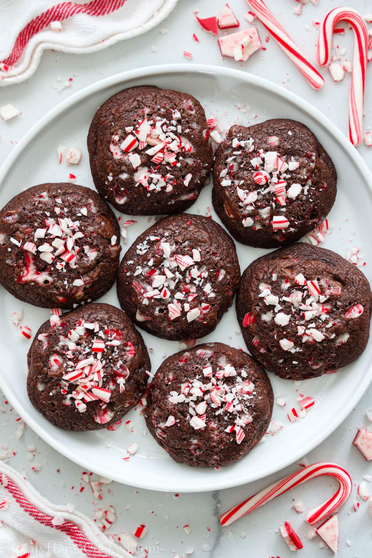 Plate of Chocolate Peppermint Cookies with candy canes nearby.