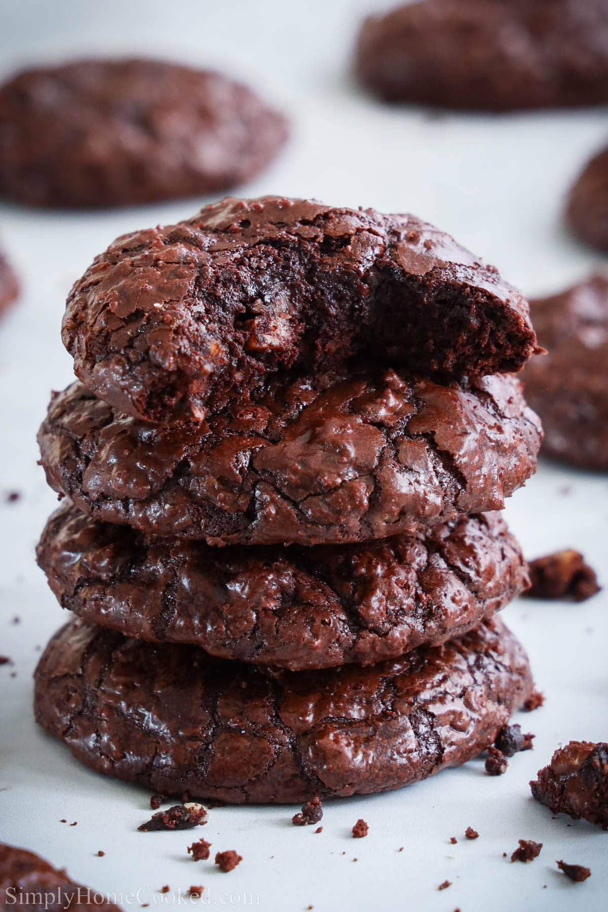 Stack of Flourless Chocolate Cookies with the top one missing a bite. 