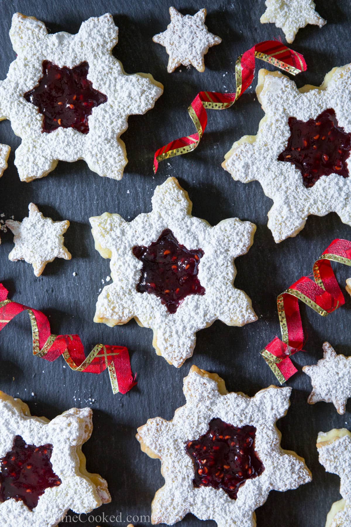 Linzer Cookies with Raspberry Jam alongside ribbons.