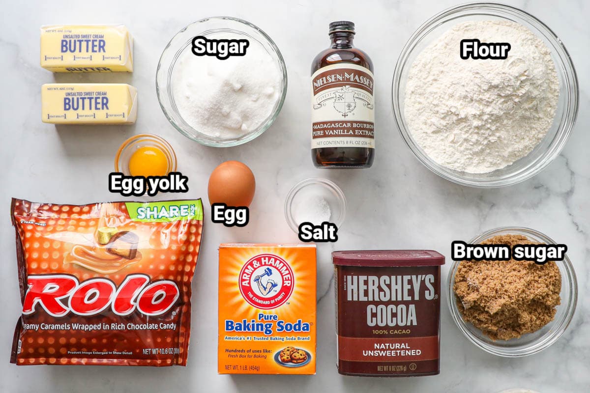Ingredients for Rolo Cookies: flour, butter, sugar, vanilla, Rolos, egg yolk, egg, salt, baking soda, brown sugar, and cocoa powder. 