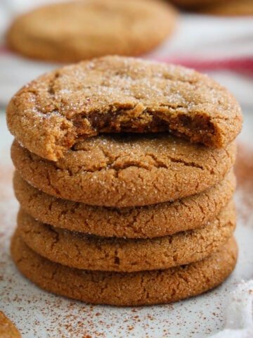 Stack of Ginger Molasses Cookies, the top one missing a bite.