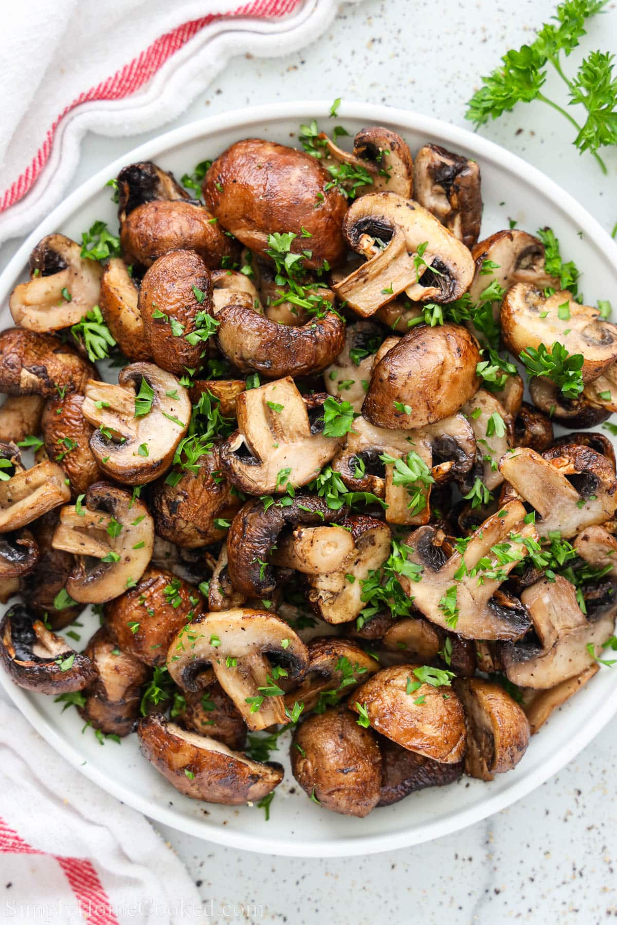 Plate of Air Fryer Mushrooms covered with chopped parsley.