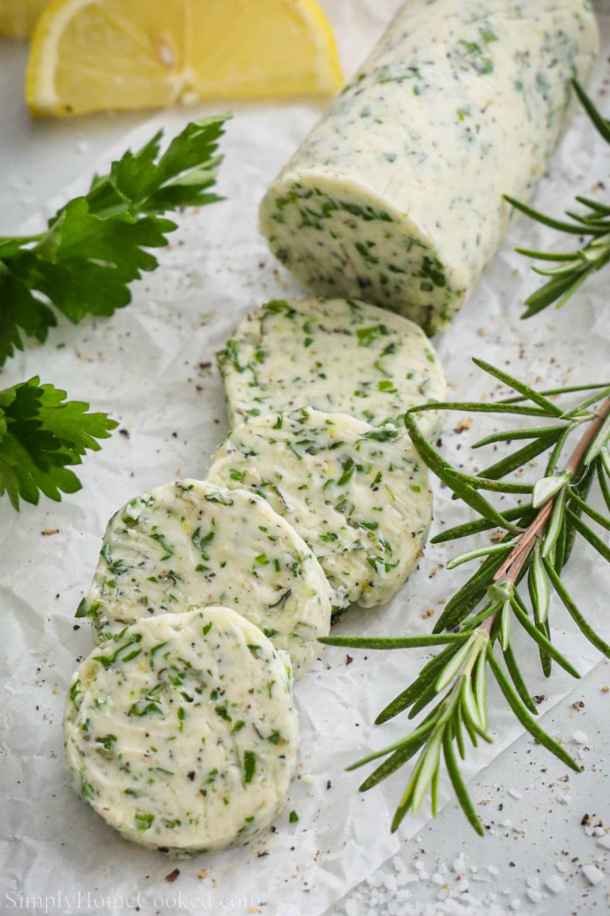 Slices of Compound Butter for Steak with fresh herbs.