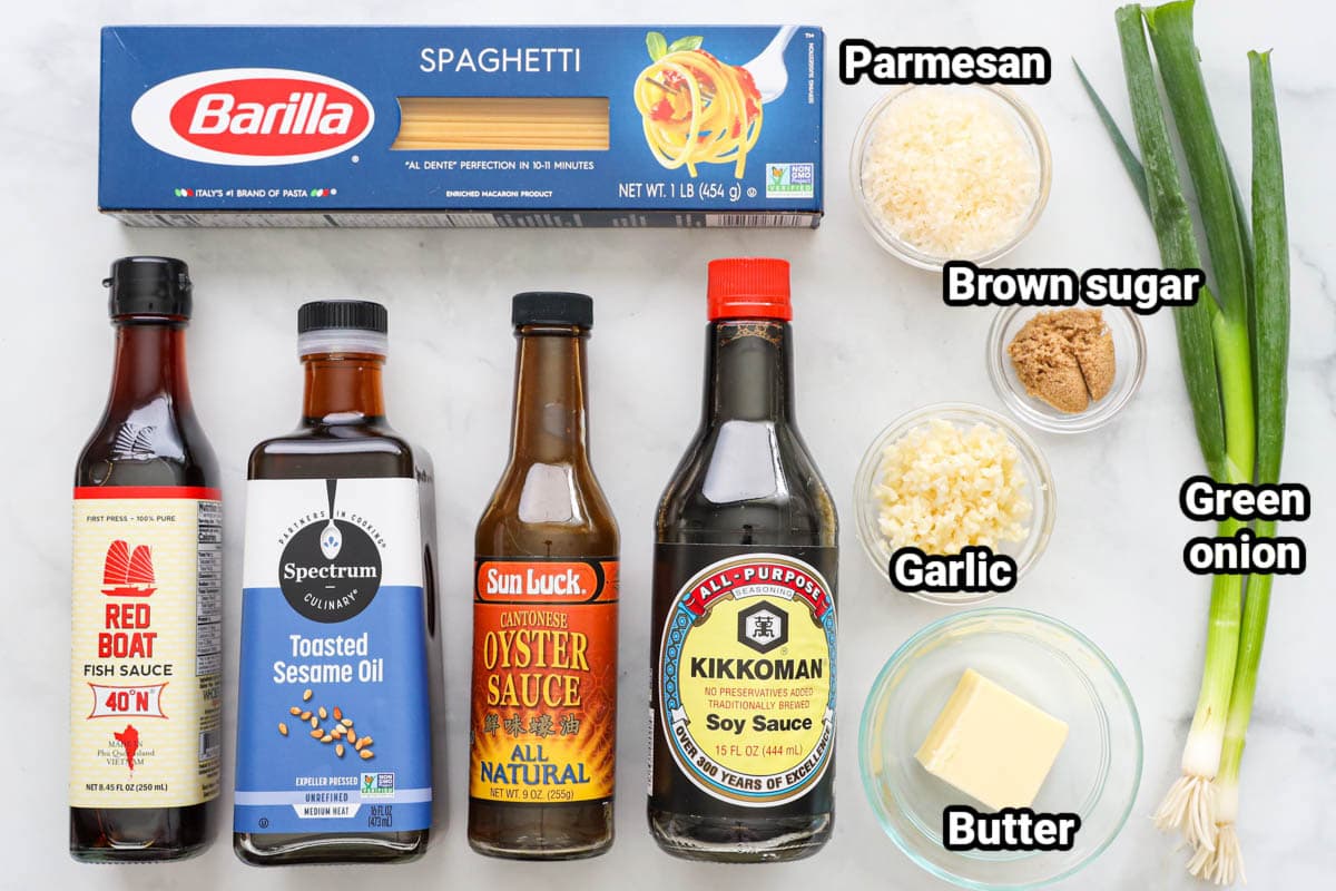 Ingredients for Garlic Noodles: spaghetti, parmesan cheese, brown sugar, garlic, butter, green onions, soy sauce, oyster sauce, sesame oil, and fish sauce.