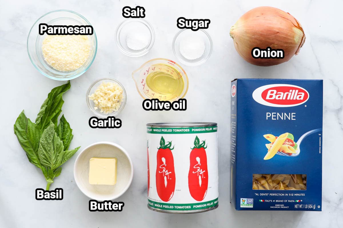Ingredients for Penne Pomodoro: parmesan, onion, garlic, salt, sugar, olive oil, butter, basil, penne, and tomatoes.