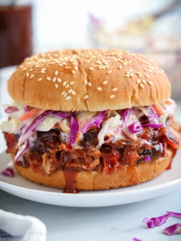 Smoked Pulled Pork on a bun with coleslaw.