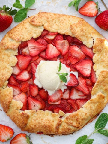 Overhead view of Strawberry galette topped with vanilla ice cream.