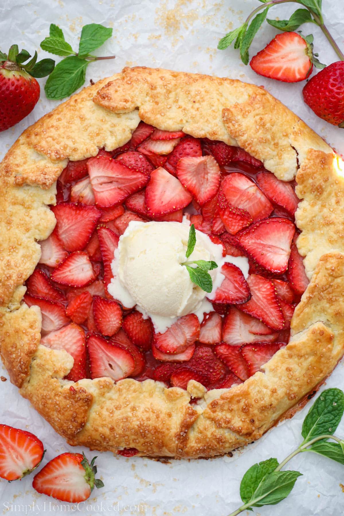 Overhead view of Strawberry galette topped with vanilla ice cream.