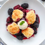 Overhead view of Blackberry Cobbler topped with ice cream.