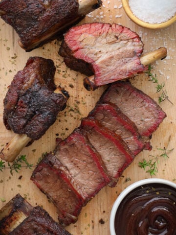 Smoked Beef Short Ribs sliced on a cutting board.