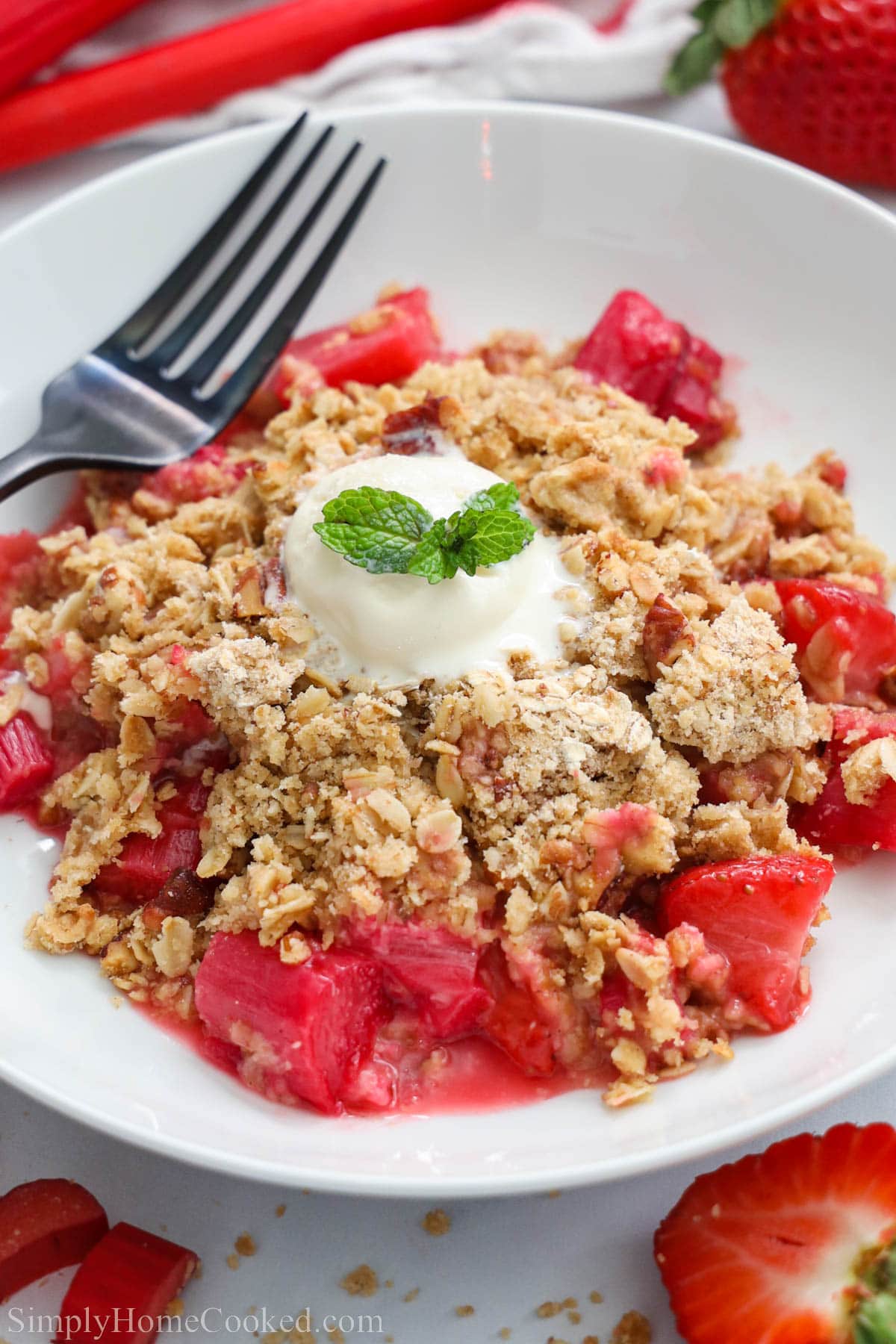 Close up of Strawberry Rhubarb Crisp with a fork.