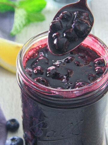 Spoonful of Blueberry Pie Filling in a jar.