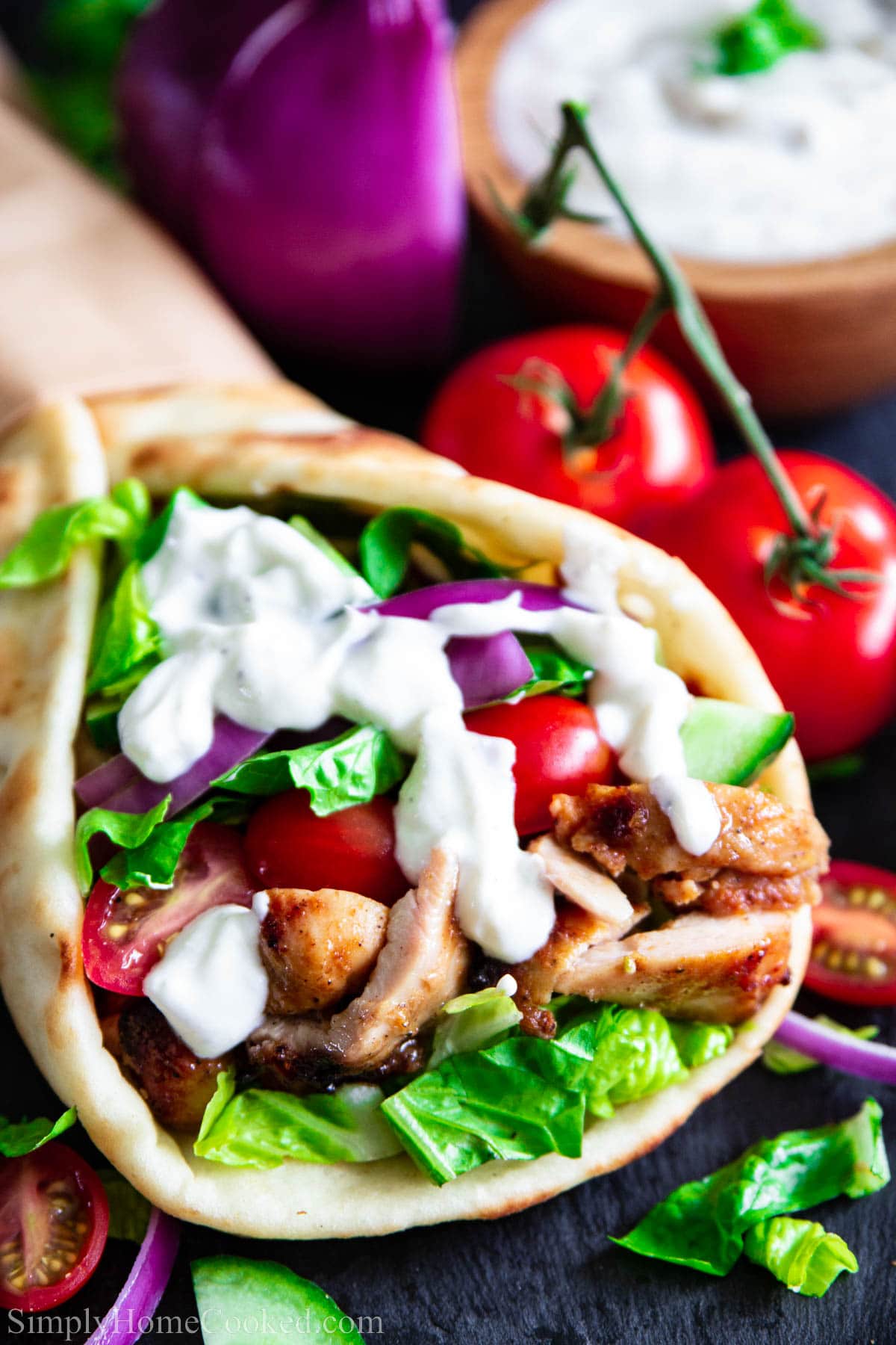 Chicken Shawarma in a pita with vegetables and yogurt sauce. 