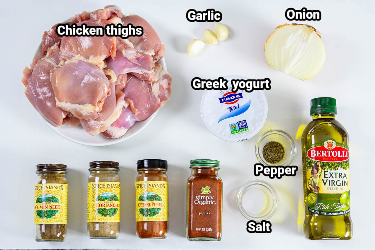 Ingredients for Chicken Shawarma: chicken thighs, garlic, onion, Greek yogurt, olive oil, salt, pepper, paprika, cayenne pepper, cumin, and coriander. 