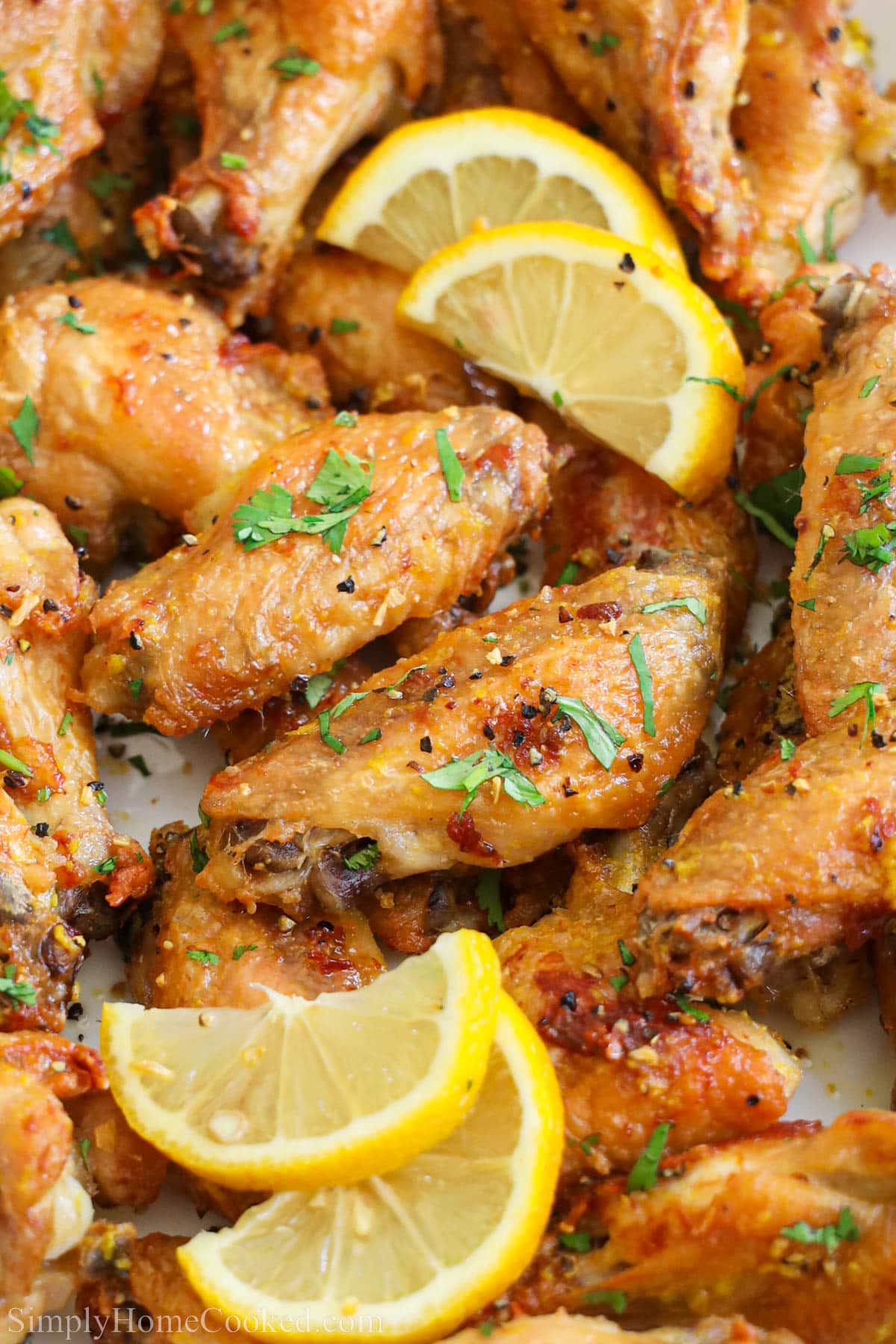 Close up of Lemon Pepper Wings with lemon slices.