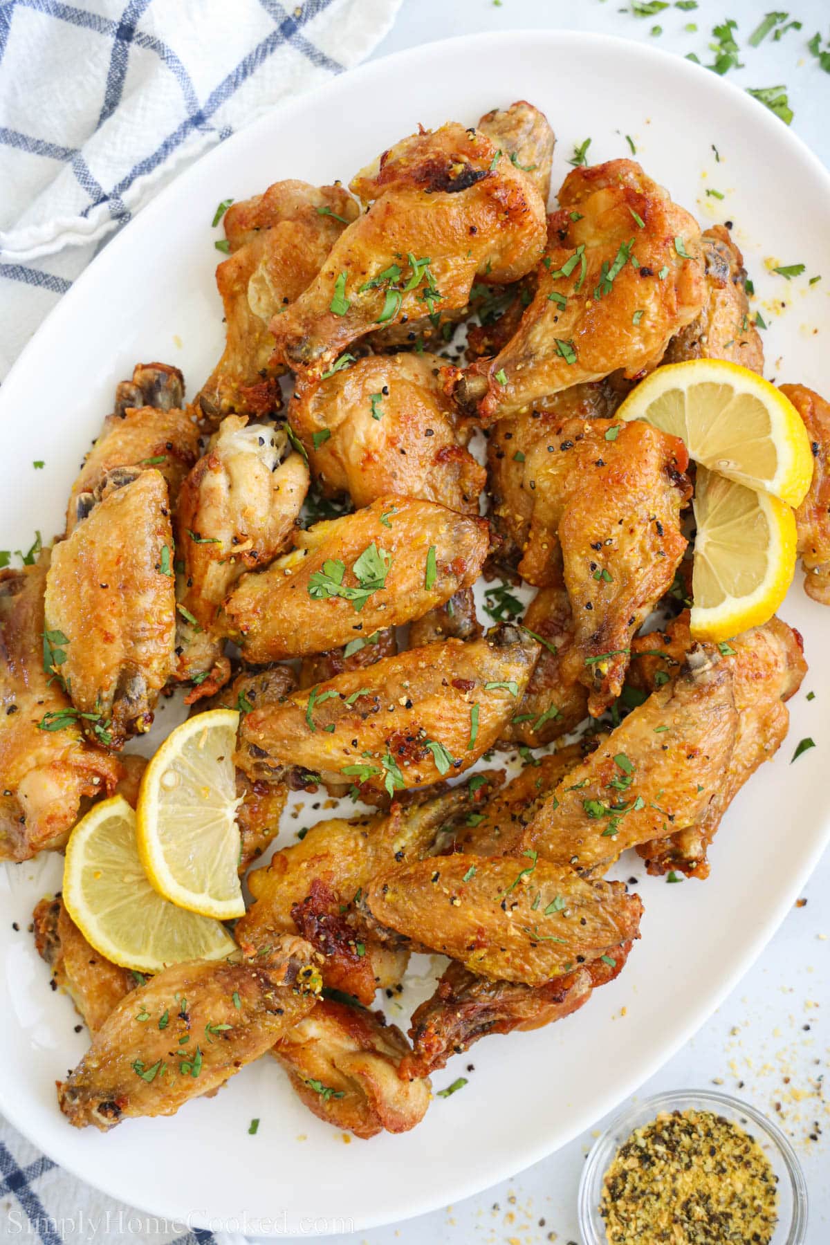 Lemon Pepper Wings with lemon slices on a plate.