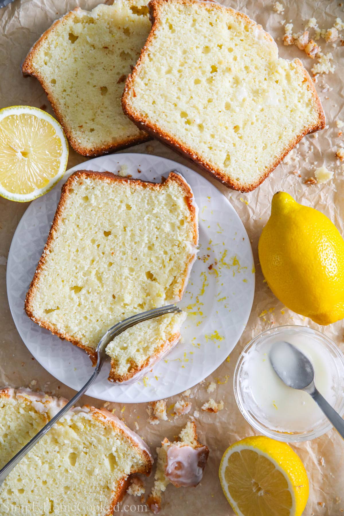 Slices of Lemon Pound Cake topped with icing on a plate.