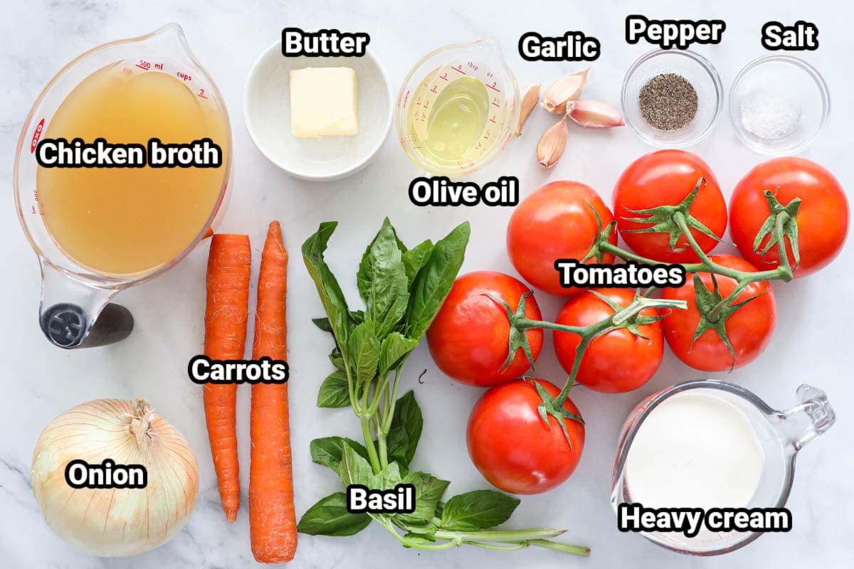 Ingredients for Tomato Basil Soup: chicken broth, butter, olive oil, garlic cloves, salt, pepper, tomatoes, basil, heavy cream, carrots, and onion. 