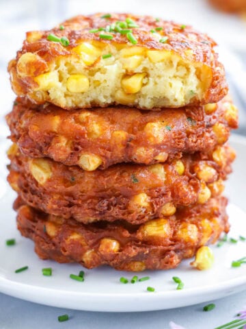 Pile of Corn Fritters, the top one missing a bite.