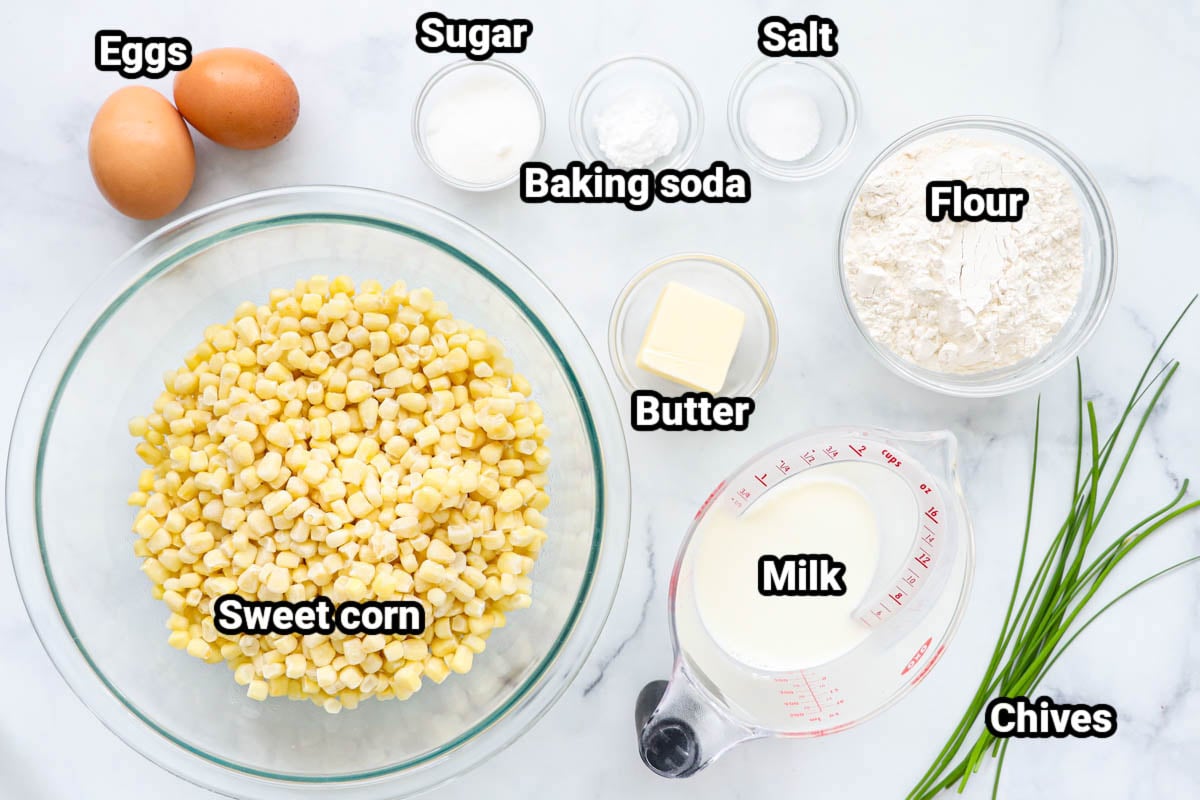 Ingredients for Corn Fritters: sweet corn, eggs, sugar, salt, baking soda, butter, flour, milk, and chives.