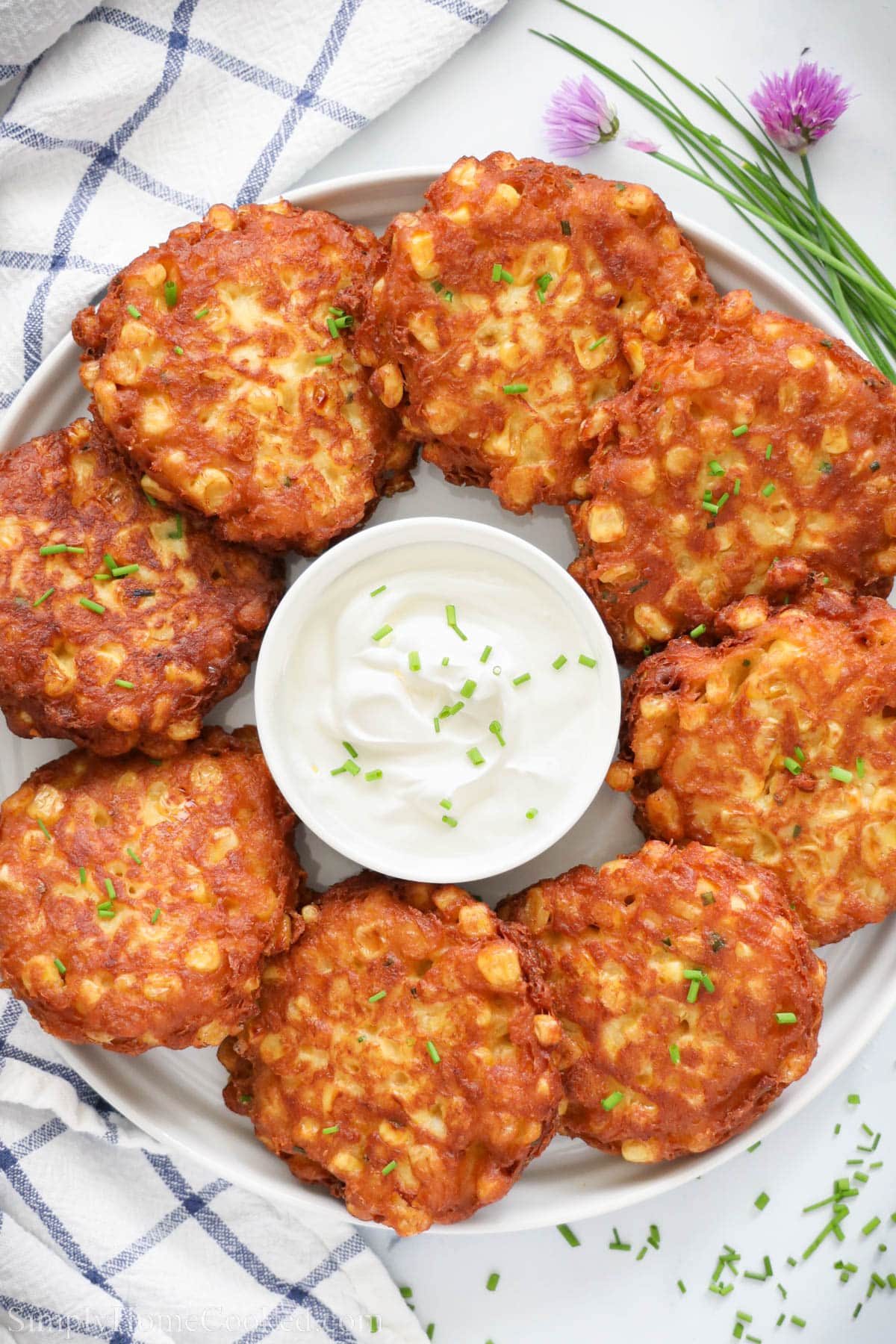 Corn Fritters surrounding a bowl of aioli. 