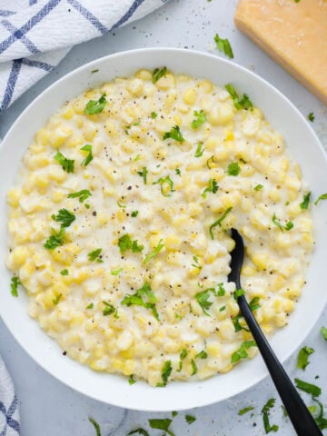 Overview of Creamed Corn garnished with parsley.