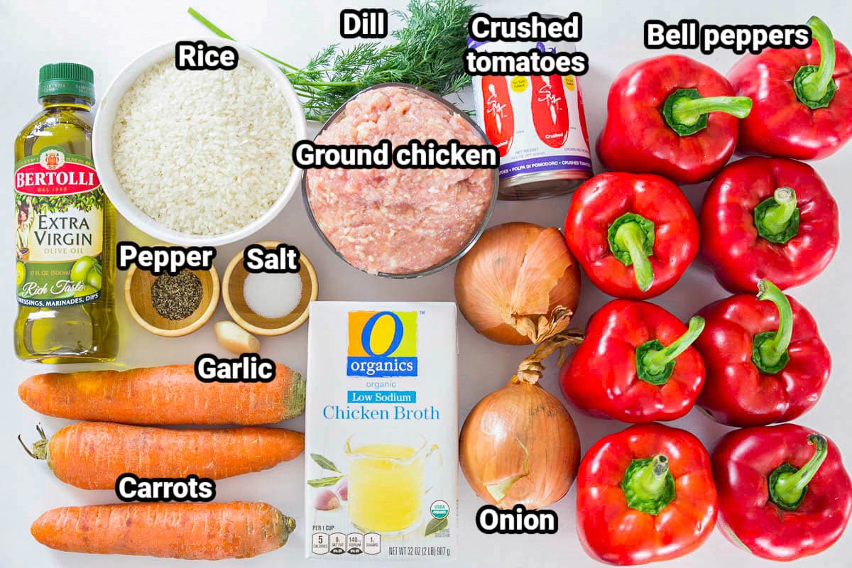 Ingredients for Chicken and Rice Stuffed Peppers: bell peppers, crushed tomatoes, onion, garlic, chicken broth, ground chicken, dill, rice, salt, pepper, carrots, and olive oil. 