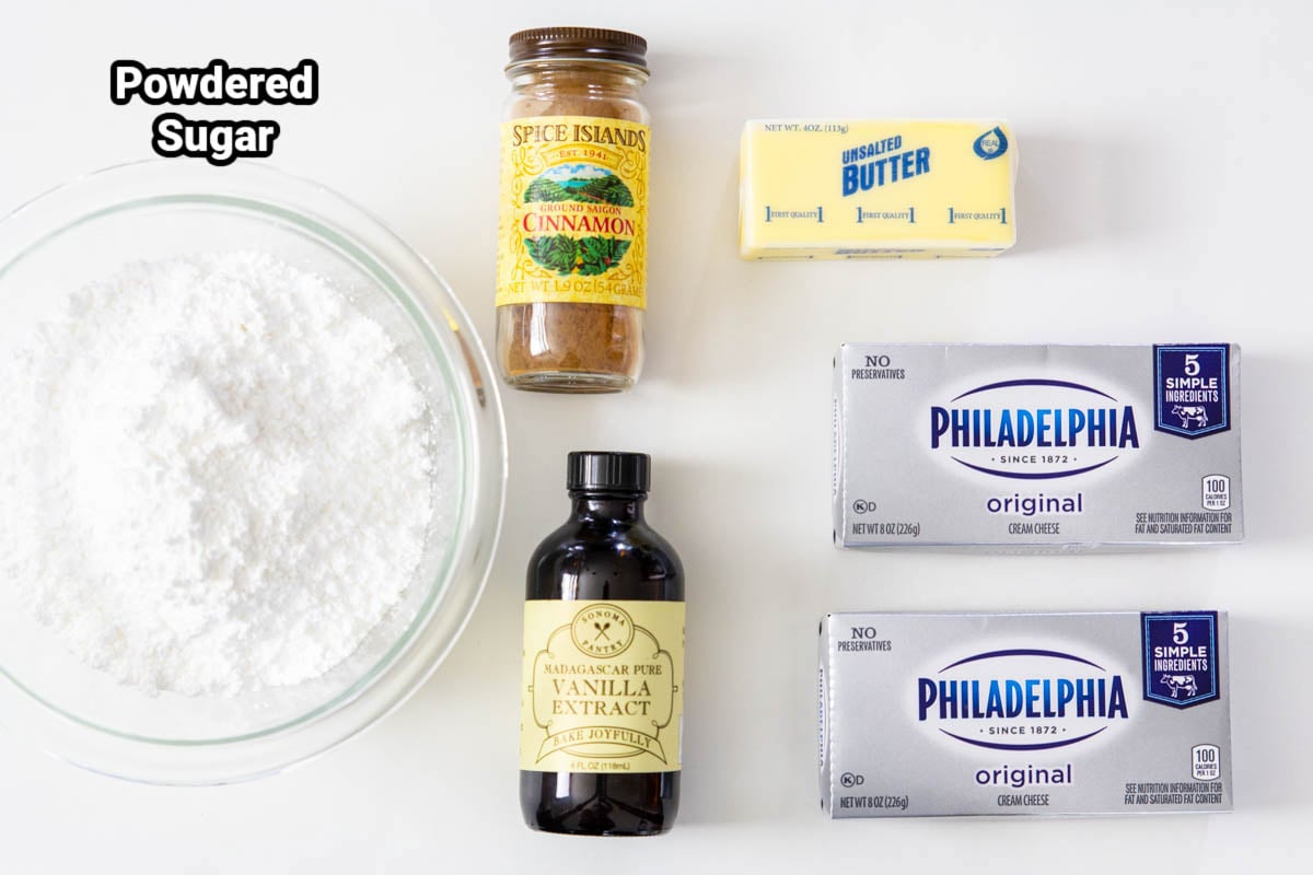 Ingredients for Cream Cheese Frosting: powdered sugar, cinnamon, vanilla, butter, and cream cheese. 