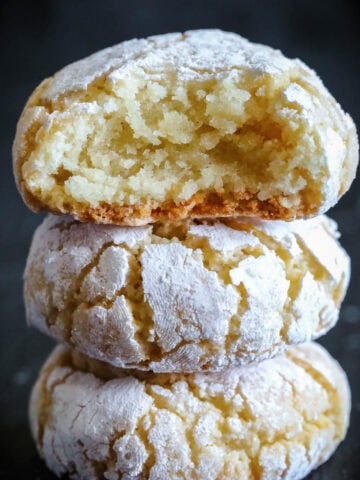 Stack of Amaretti Cookies with the top one missing a bite.