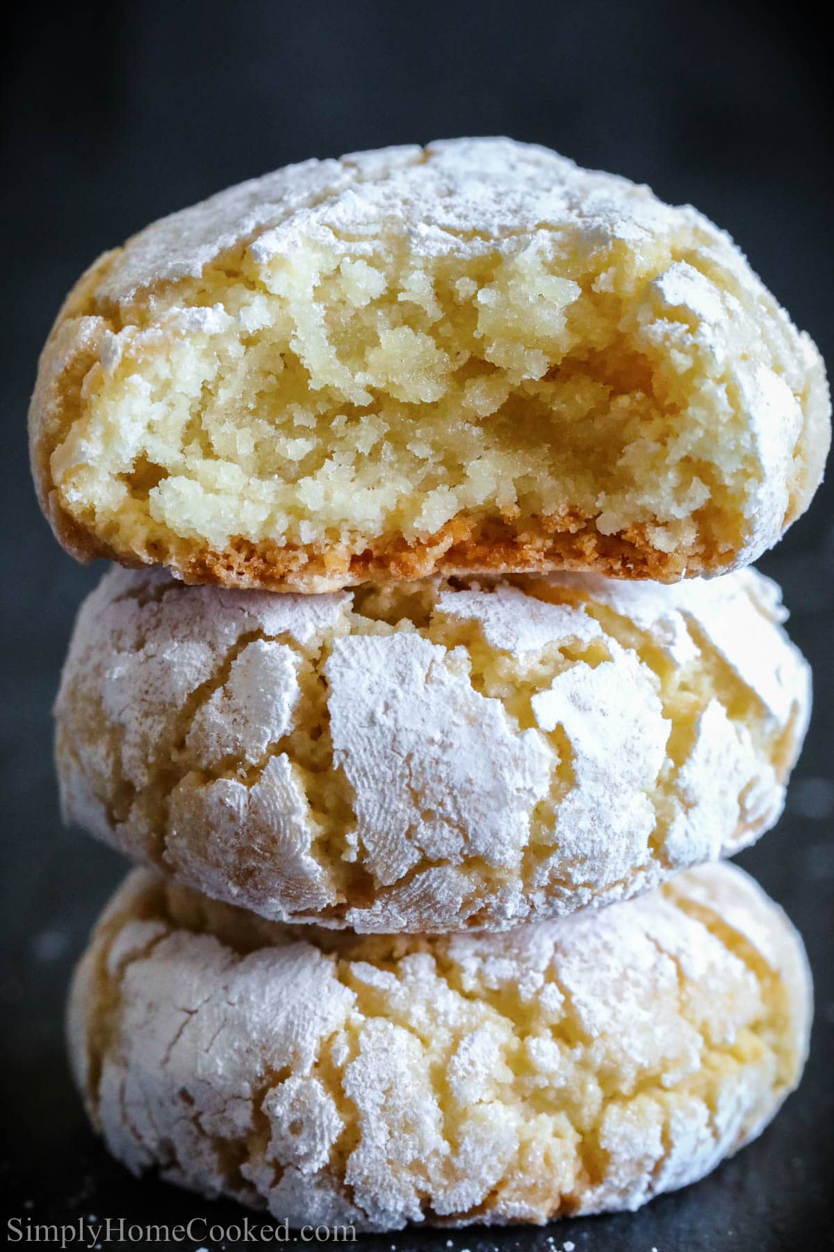 Stack of Amaretti Cookies with the top one missing a bite.