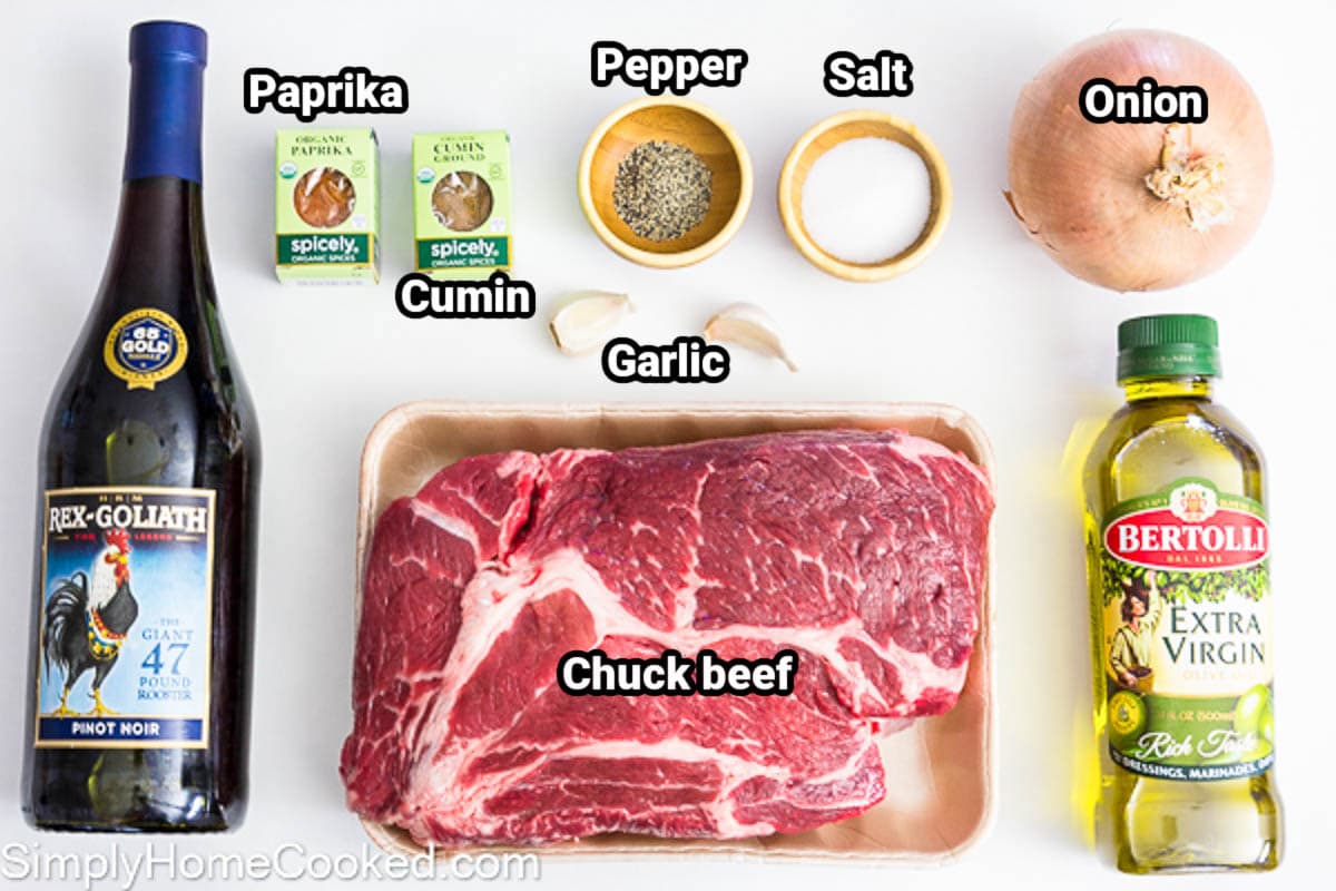 Ingredients for Braised Beef: red wine, cumin, paprika, garlic, black pepper, salt, onion, chuck beef, and olive oil.