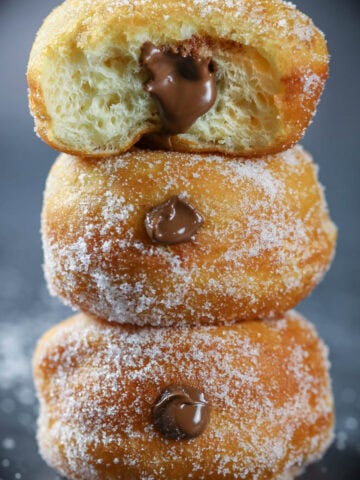 Stack of Brioche Donuts with chocolate custard filling.