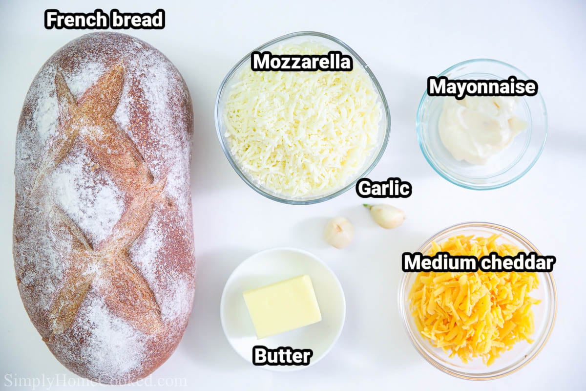 Ingredients for Garlic Cheese Bread: French bread, mozzarella, mayonnaise,  garlic cloves, medium cheddar cheese, and butter.