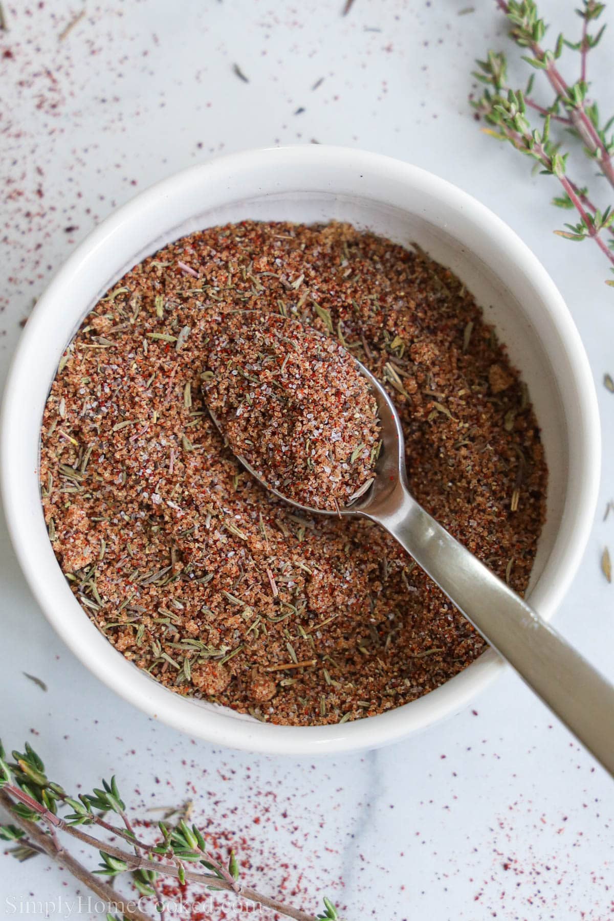 Overhead view of a bowl of Salmon Seasoning with a spoon in it. 