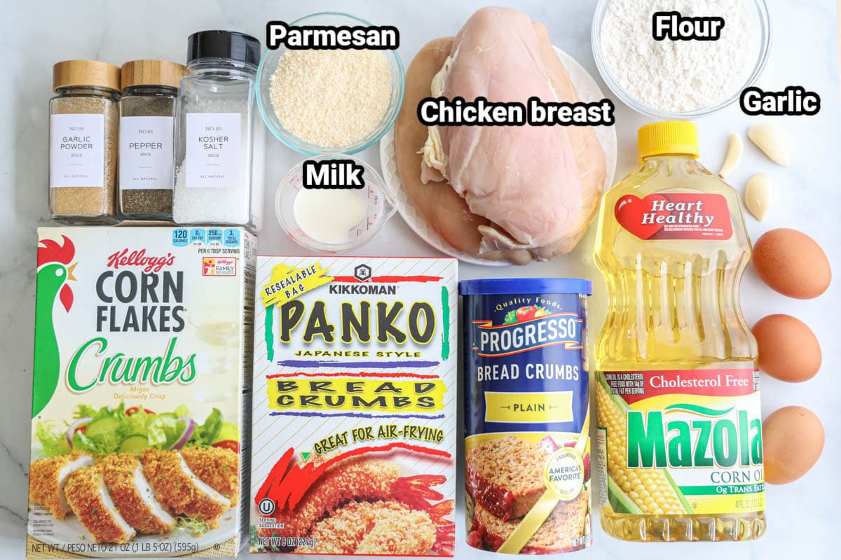 Ingredients for Chicken Cutlets: chicken breasts, flour, garlic cloves, eggs, corn oil, milk, parmesan cheese, kosher salt, pepper, garlic powder, cornflakes crumbs, panko breadcrumbs, and plain breadcrumbs. 