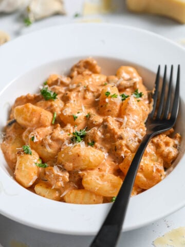 Creamy Sausage Gnocchi in a bowl with a fork.