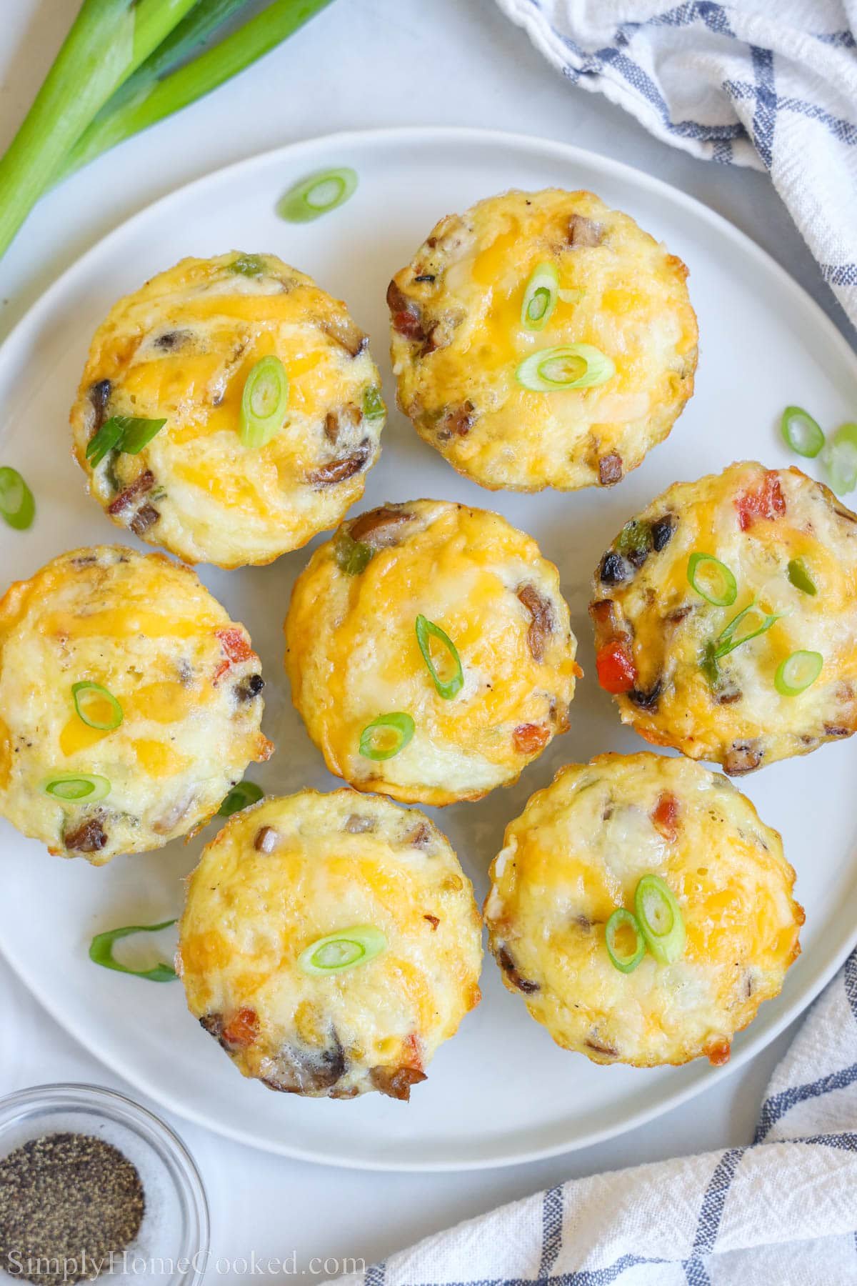 Overview of a plate of Egg Bites topped with green onion. 