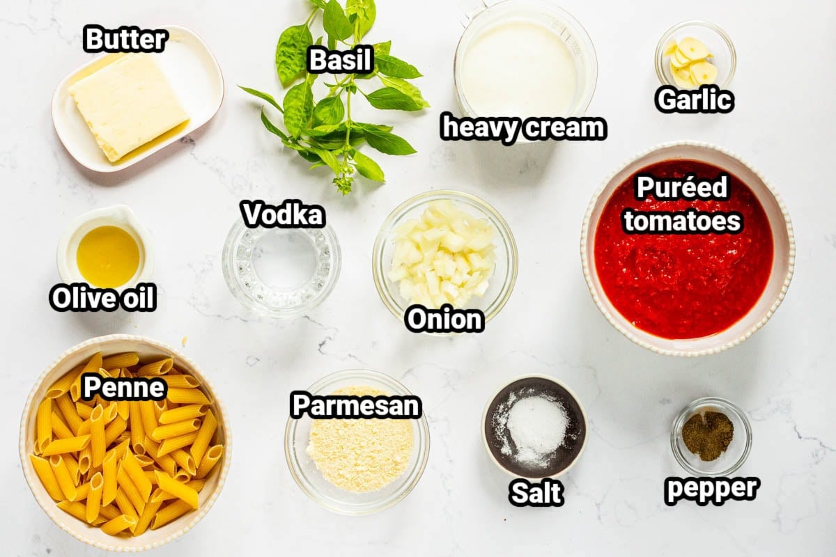 Ingredients for Penne Alla Vodka: butter, basil, heavy cream, garlic, olive oil, vodka, onion, pureed tomatoes, penne, parmesan, salt, and pepper.