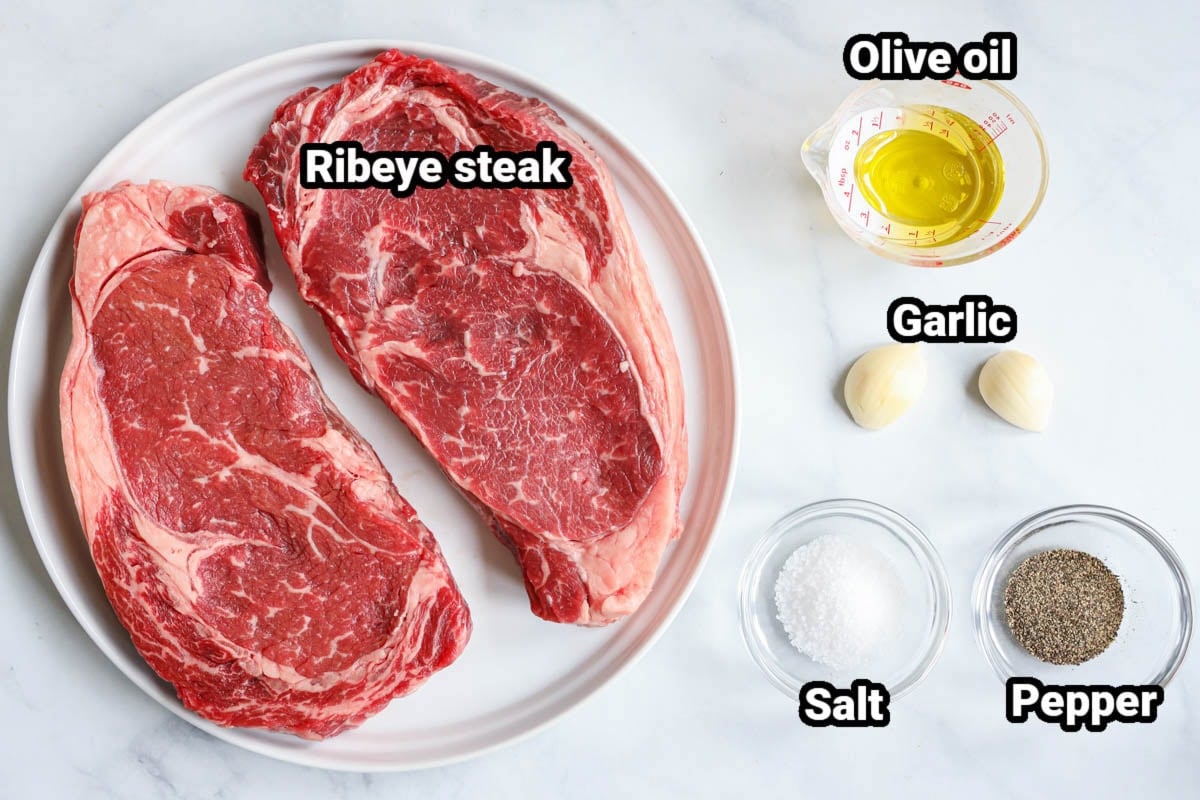 Ingredients for Grilled Ribeye Steak: ribeye steak, olive oil, garlic, salt, and pepper.