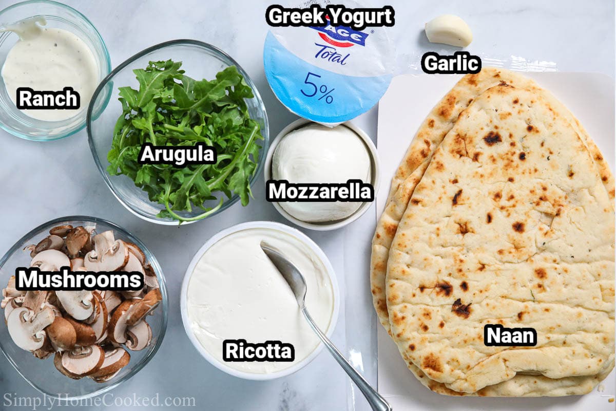 Ingredients for Mushroom Arugula Flatbread Pizza: naan, garlic, ricotta, mozzarella, Greek yogurt, arugula, ranch, and mushrooms.