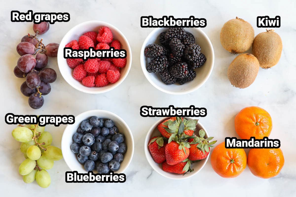 Ingredients for Fruit Kabobs: red grapes, ,green grapes, raspberries, blackberries, kiwi, strawberries, mandarin oranges, and blueberries.