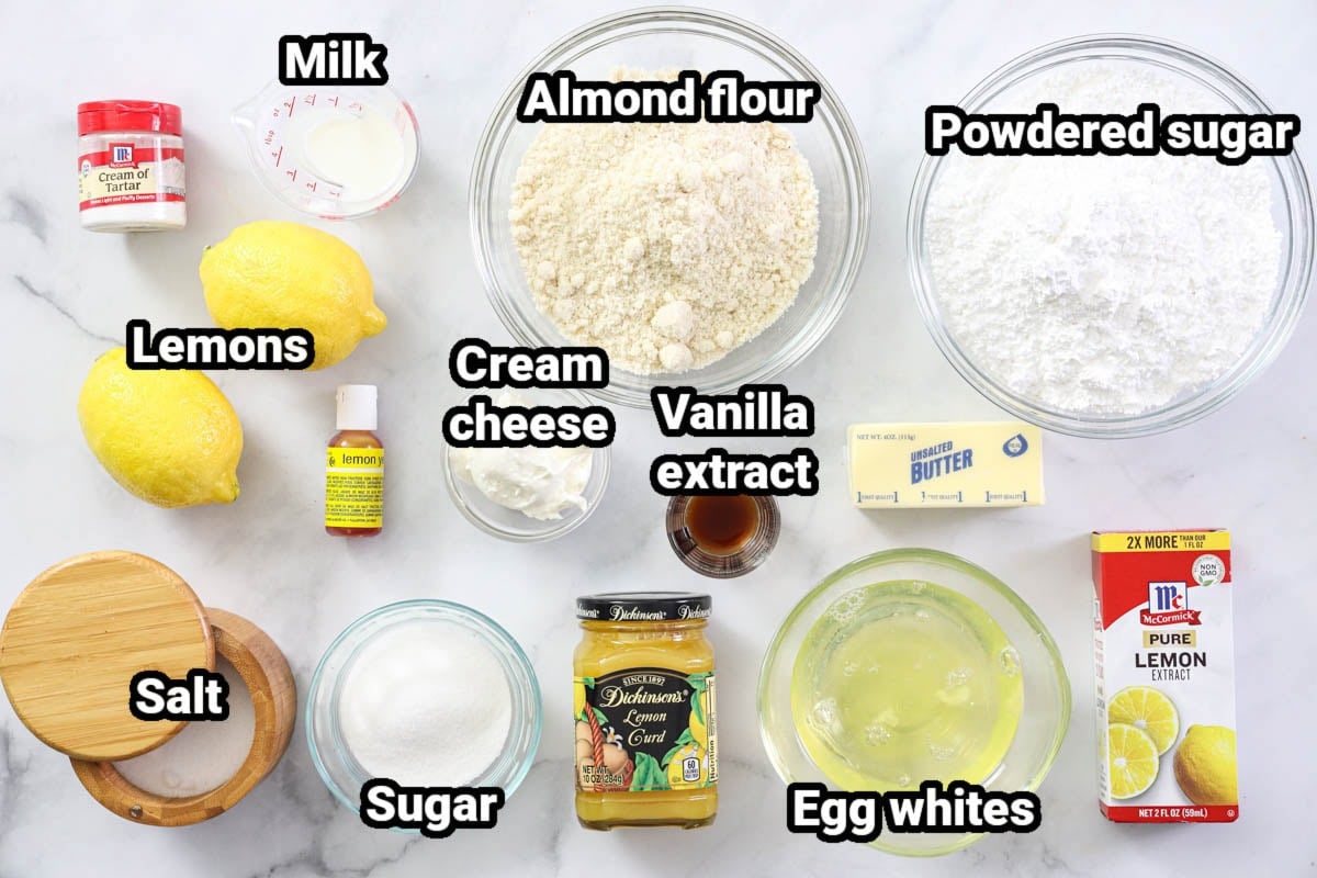 Ingredients for Lemon Macarons: powdered sugar, almond flour, milk, cream of tartar, lemons, lemon extract, vanilla extract, cream cheese, butter, egg whites, salt, sugar, lemon food coloring, and lemon curd.