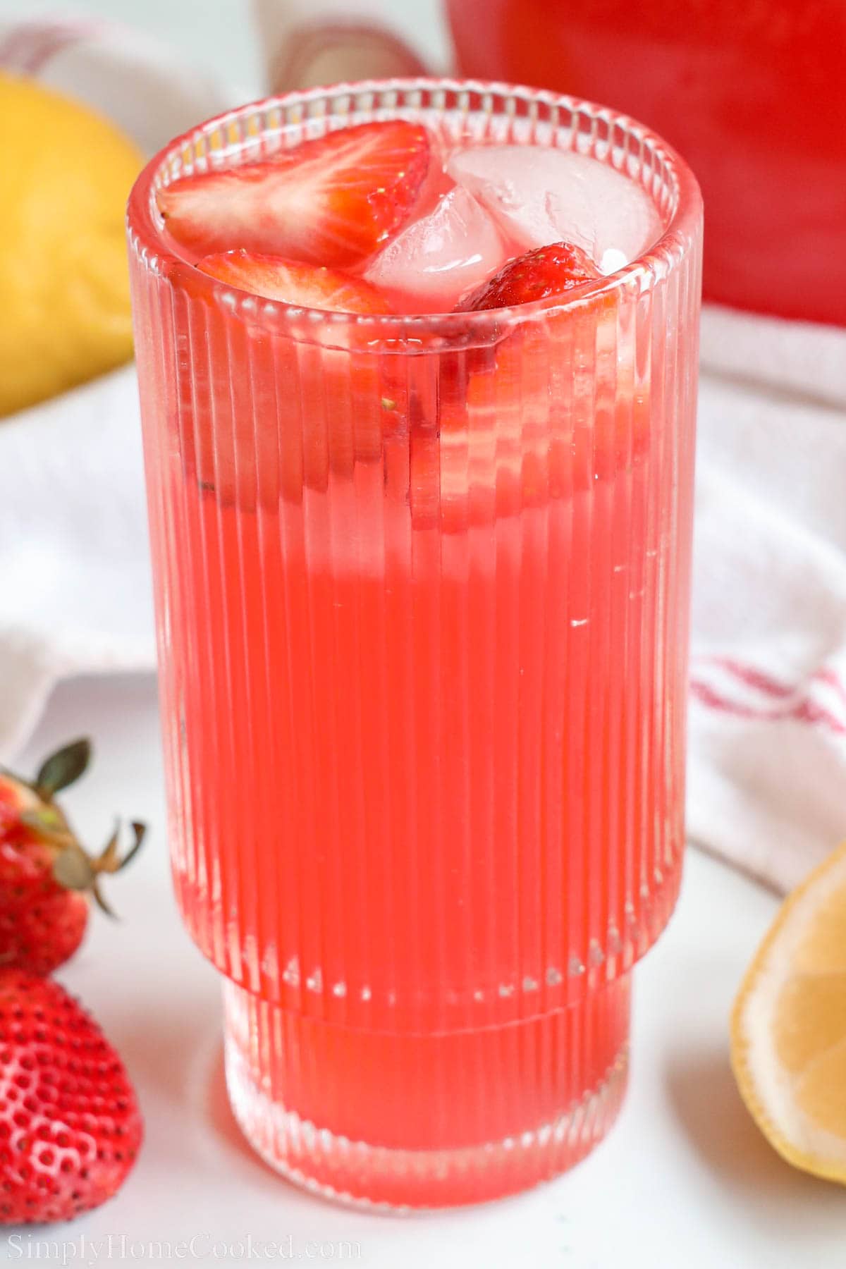 Sparkling Fruit Punch in a glass with ice and sliced strawberries. 