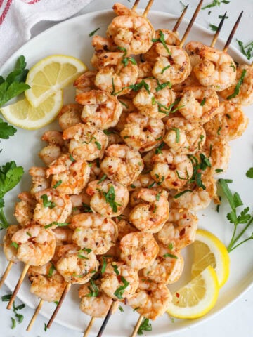 Grilled Shrimp on skewers and topped with chopped parsley.