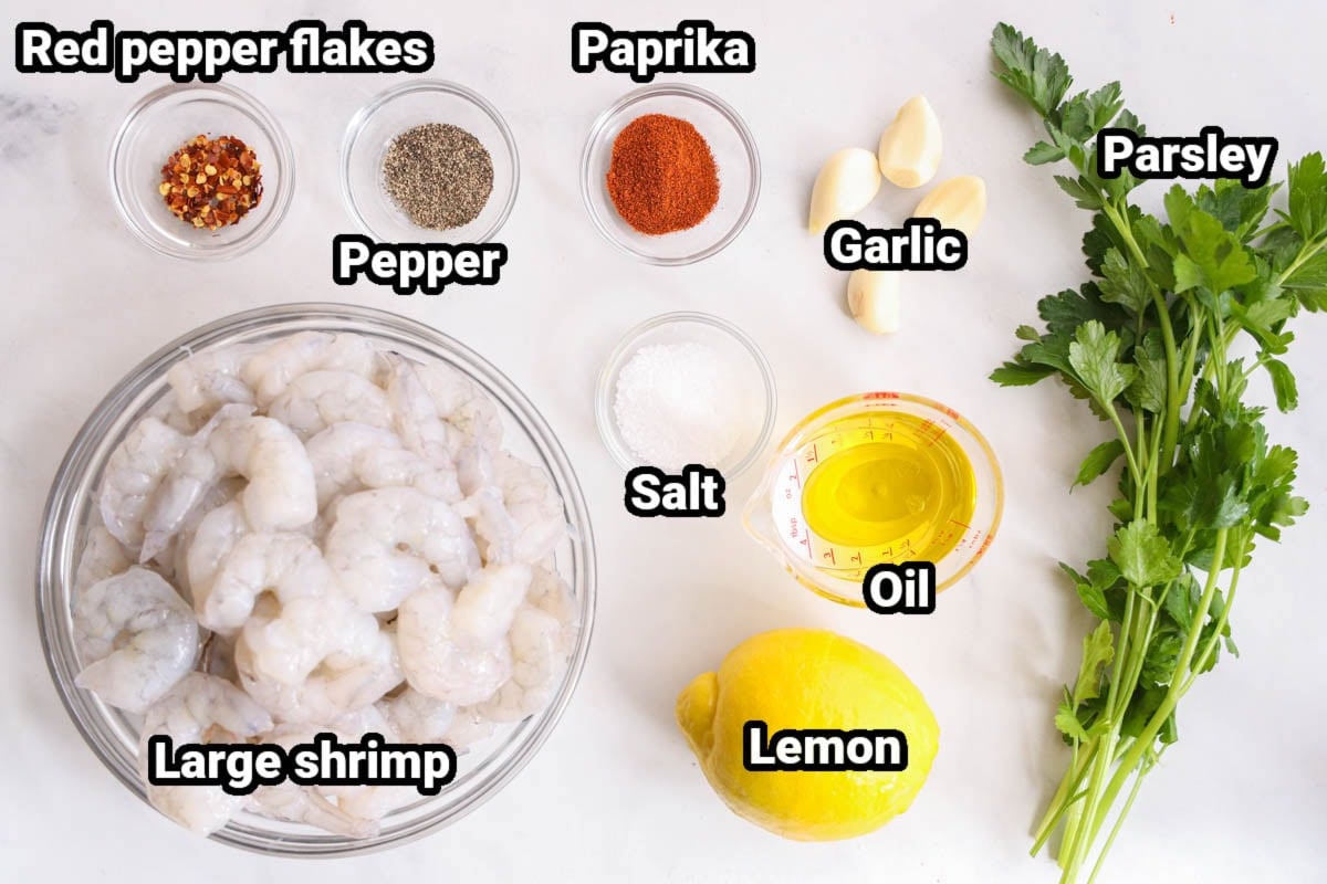 Ingredients for Grilled Shrimp: large shrimp, red pepper flakes, pepper, paprika, garlic, salt, oil, lemon juice, and parsley. 