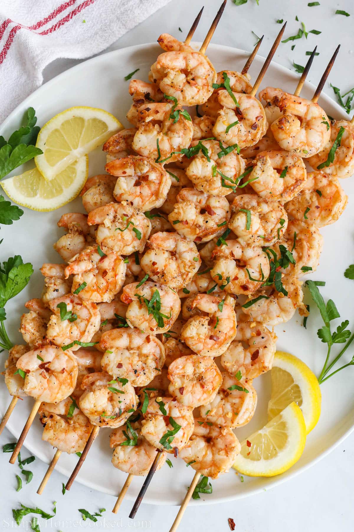 Grilled Shrimp on skewers and topped with chopped parsley.